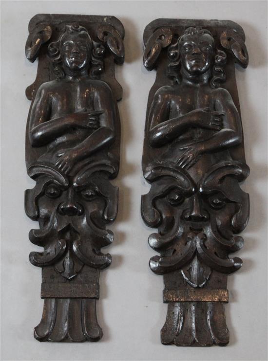 A pair of 18th century oak corbels, 17in.